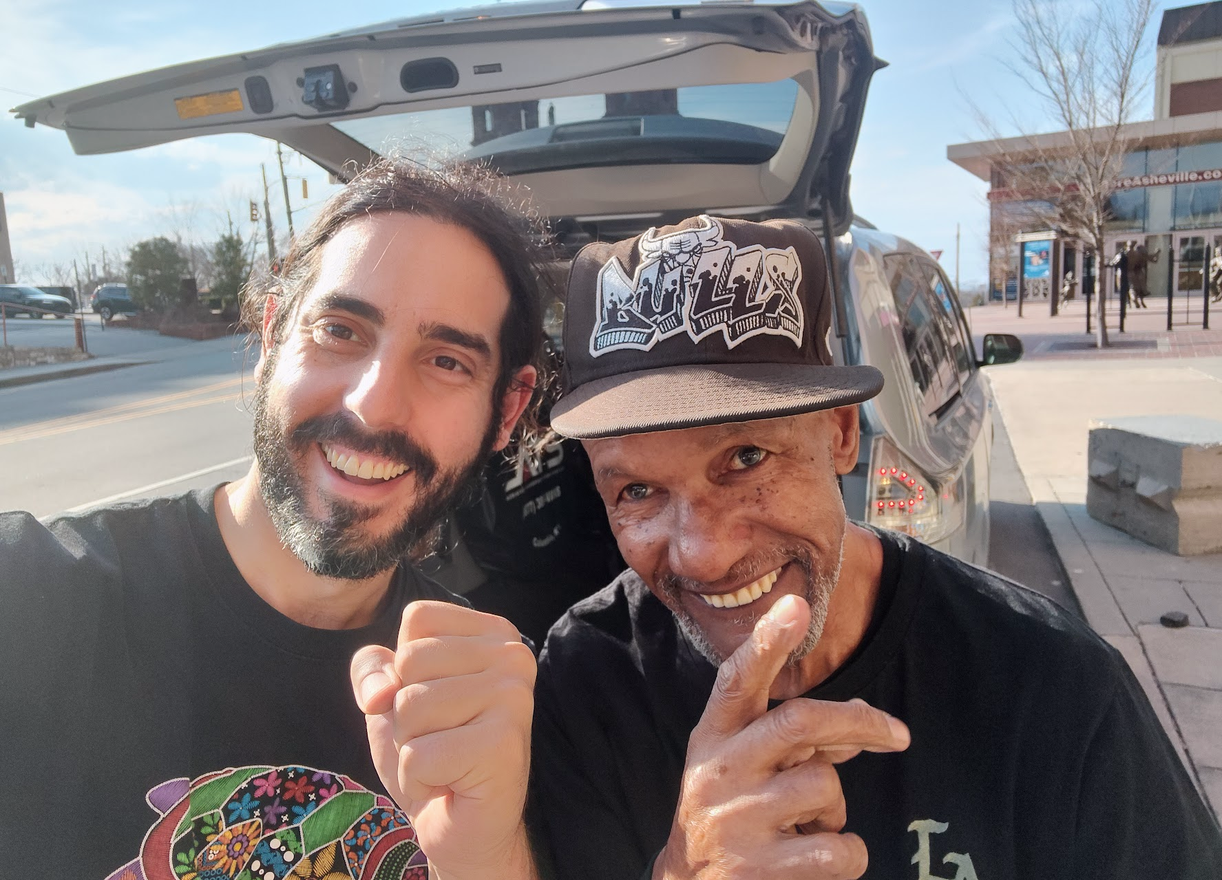 Two men smiling at the camera.