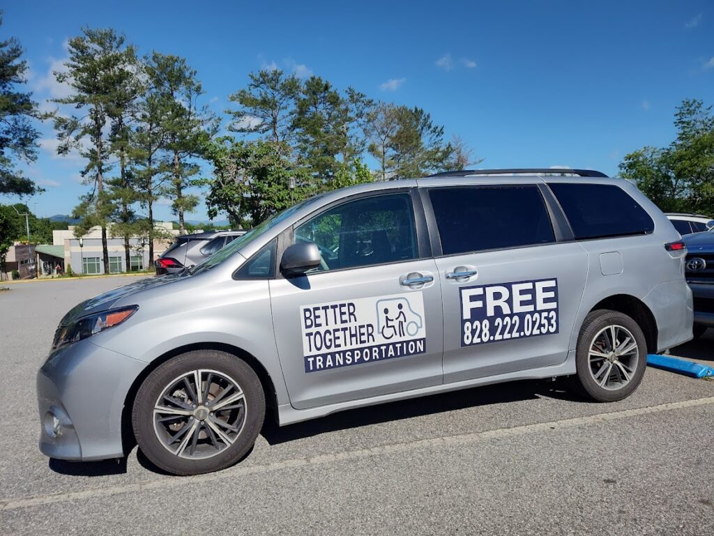 A silver van parked in a parking lot.